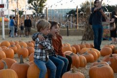 10/09/2019 – LONG BEACH, CALIF: Logan and Linus share a hug with their friend before he leaves to examine the pumpkins. Photograph by Dillon Hulse