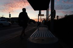 11/14/19 – LONG BEACH, CALIF: A man walks by the bus stop near the corner of Anaheim and Ximeno. Photograph by Dillon Hulse.