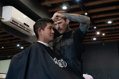 Tyler Arnoldi, right, works on the finer details of Roman De Jesus' haircut at The Lodge Barber Company in Long Beach on Tuesday, Feb. 11, 2020. Photograph by Dillon Hulse.