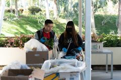 Post-baccalaureate student Grace Choi, right, and Steve Ly, first-year school psychology major, look through the produce at the ASI Beach Pantry Pop-up Tuesday, March 17, 2020. Long Beach State announced Tuesday morning that classes will be conducted online for the remainder of the semester starting Monday, March 23. Photograph by Dillon Hulse.